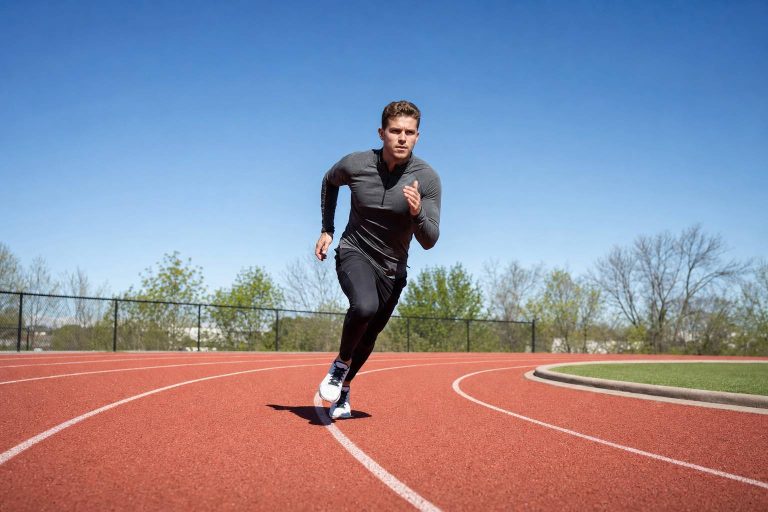 A runner working hard through a track curve at speed