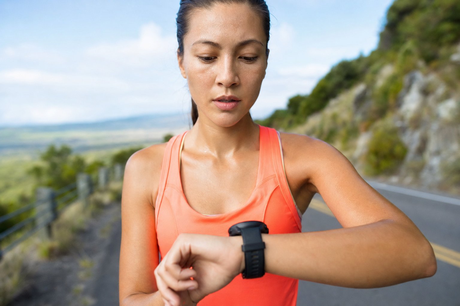A runner checking pace on a sports watch mid run